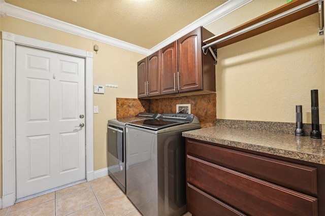 1478 Brigadier Dr, Spring Hill, FL 34608 - washroom featuring cabinet space, washing machine and dryer, crown molding, light tile patterned flooring, and a textured ceiling