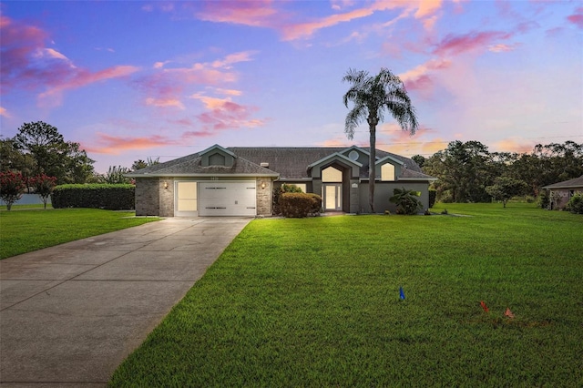 1478 Brigadier Dr, Spring Hill, FL 34608 - view of front of property featuring concrete driveway, an attached garage, a front lawn, and brick siding
