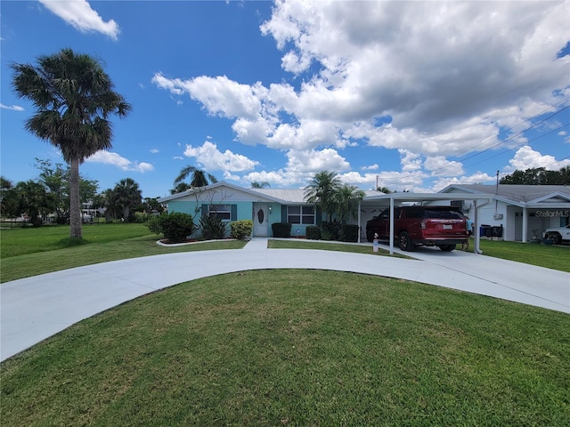 6737 Clark St, Hudson, FL 34667 - ranch-style house featuring curved driveway, a front yard, and a carport