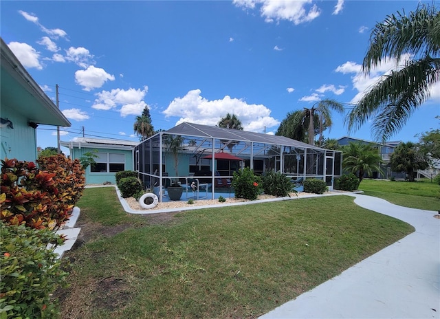 6737 Clark St, Hudson, FL 34667 - rear view of property with a lawn and a lanai