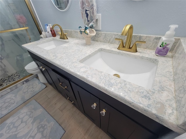 6737 Clark St, Hudson, FL 34667 - full bathroom with double vanity, a shower stall, and wood finished floors