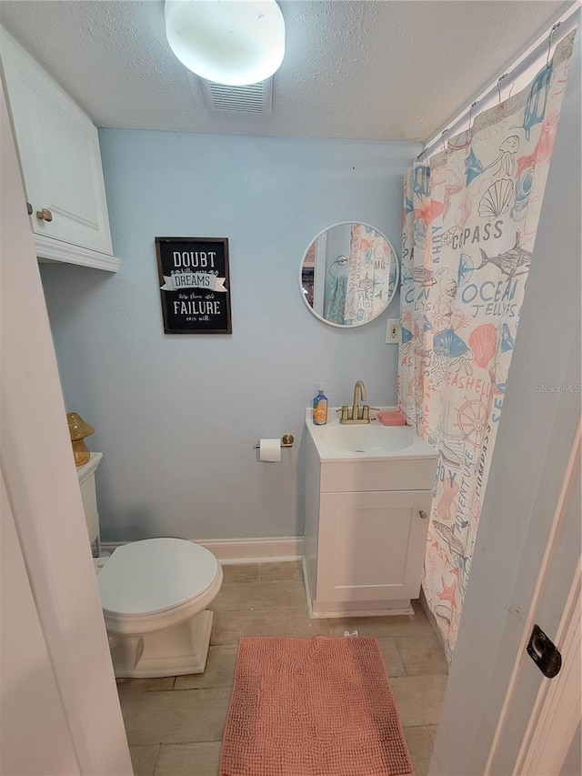 6737 Clark St, Hudson, FL 34667 - bathroom with vanity, a textured ceiling, tile patterned flooring, and a shower with shower curtain