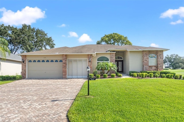 7328 Blue Skies Dr, Spring Hill, FL 34606 - view of front of home featuring decorative driveway, an attached garage, a front lawn, and stucco siding