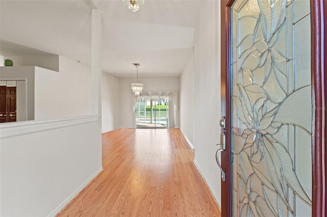 7328 Blue Skies Dr, Spring Hill, FL 34606 - foyer featuring wood finished floors and a chandelier