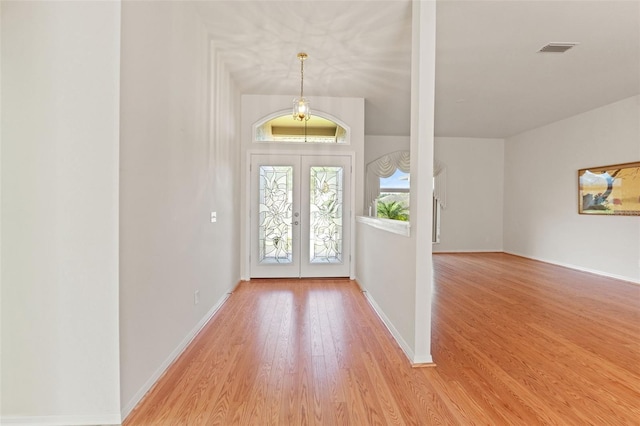 7328 Blue Skies Dr, Spring Hill, FL 34606 - foyer with french doors and light wood-type flooring