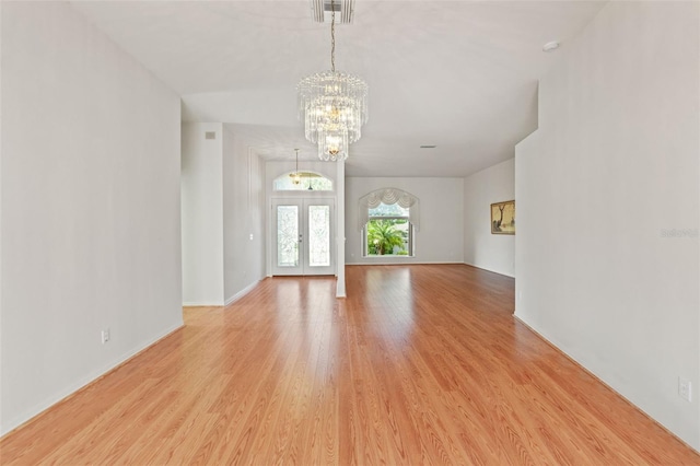 7328 Blue Skies Dr, Spring Hill, FL 34606 - spare room featuring a chandelier and light wood-style flooring