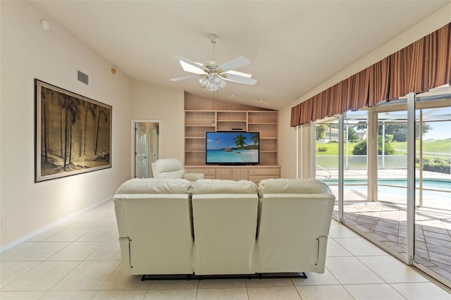 7328 Blue Skies Dr, Spring Hill, FL 34606 - living room with vaulted ceiling, light tile patterned flooring, a ceiling fan, and built in shelves