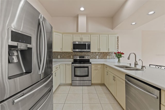 7328 Blue Skies Dr, Spring Hill, FL 34606 - kitchen featuring stainless steel appliances, cream cabinets, light countertops, light tile patterned floors, and recessed lighting