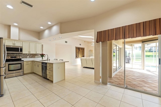 7328 Blue Skies Dr, Spring Hill, FL 34606 - kitchen with appliances with stainless steel finishes, light tile patterned floors, a peninsula, open floor plan, and recessed lighting