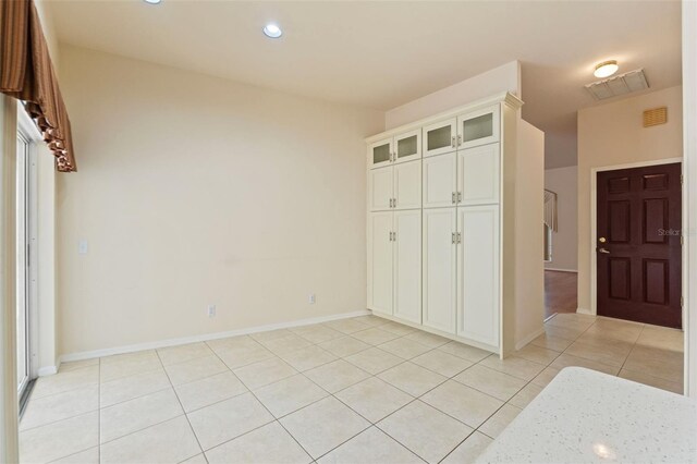 7328 Blue Skies Dr, Spring Hill, FL 34606 - unfurnished bedroom with light tile patterned flooring, a closet, and recessed lighting