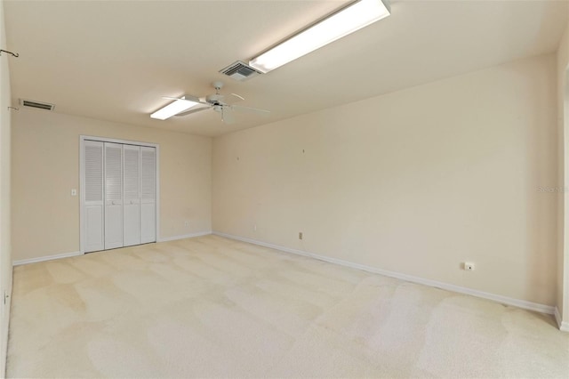 7328 Blue Skies Dr, Spring Hill, FL 34606 - unfurnished bedroom featuring light carpet, a closet, and a ceiling fan