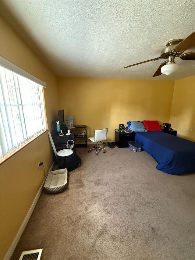 5635 Kimball Rd, Mulberry, FL 33860 - unfurnished bedroom featuring carpet, a textured ceiling, and ceiling fan