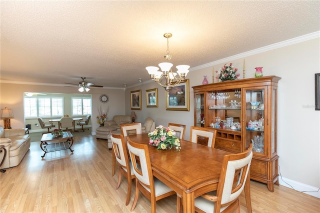 4452 Garnet Dr Unit 302, New Port Richey, FL 34652 - dining space with light wood finished floors, ceiling fan, a chandelier, a textured ceiling, and ornamental molding
