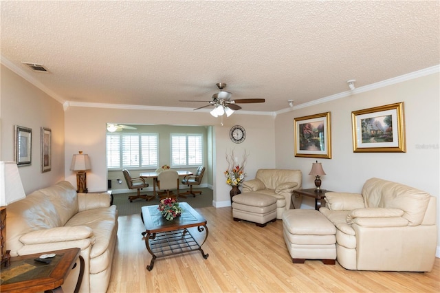 4452 Garnet Dr Unit 302, New Port Richey, FL 34652 - living room featuring light wood finished floors, ceiling fan, a textured ceiling, and crown molding