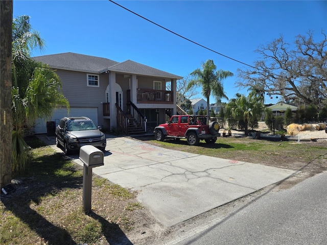 5420 Bay Blvd, Port Richey, FL 34668 - view of front of house featuring stairs, driveway, a garage, and covered porch