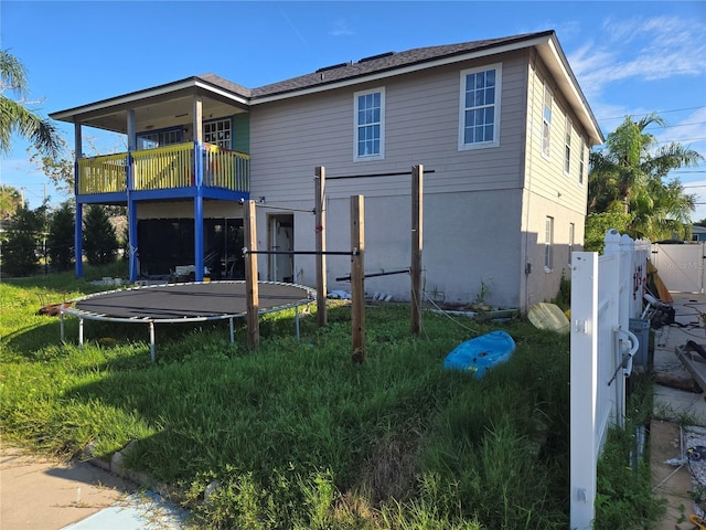 5420 Bay Blvd, Port Richey, FL 34668 - rear view of property with a trampoline and a balcony