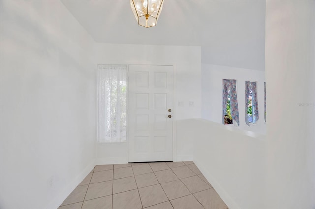 8143 Channel Dr, Port Richey, FL 34668 - entrance foyer featuring light tile patterned floors and baseboards