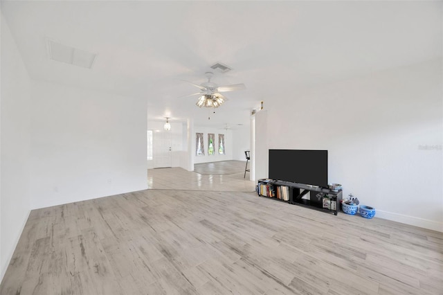 8143 Channel Dr, Port Richey, FL 34668 - unfurnished living room with wood finished floors and a ceiling fan