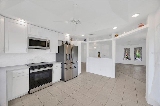 8143 Channel Dr, Port Richey, FL 34668 - kitchen featuring appliances with stainless steel finishes, a ceiling fan, light countertops, white cabinetry, and backsplash