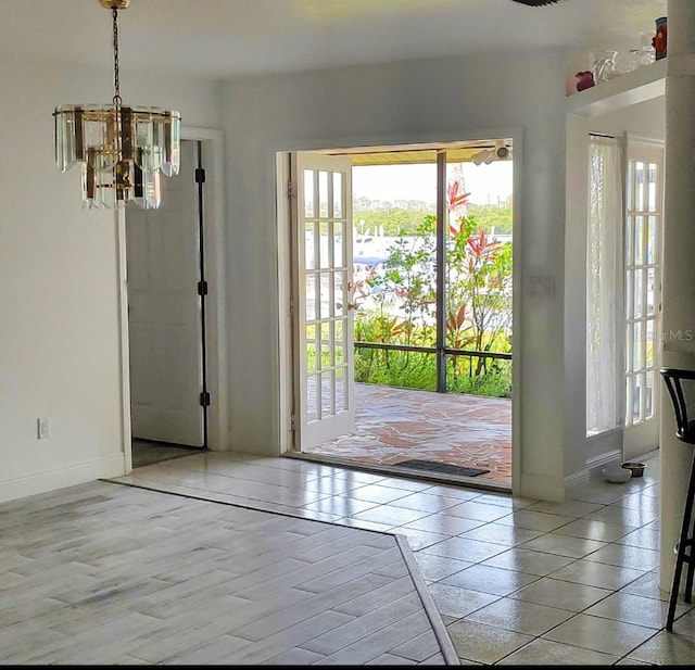 8143 Channel Dr, Port Richey, FL 34668 - entryway with plenty of natural light, a chandelier, and tile patterned floors