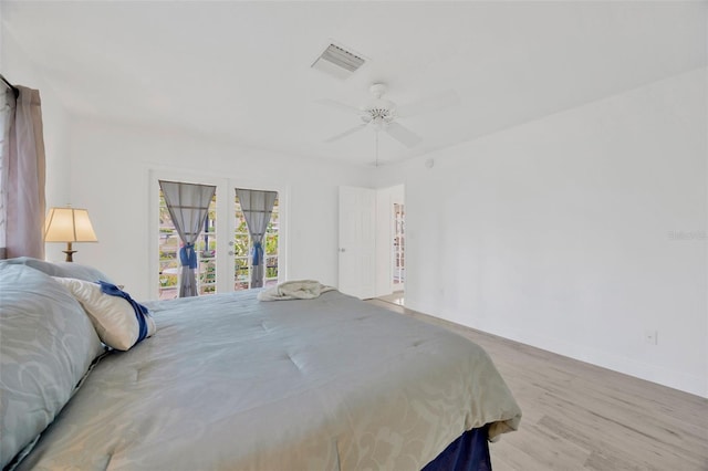 8143 Channel Dr, Port Richey, FL 34668 - bedroom featuring french doors, wood finished floors, and ceiling fan
