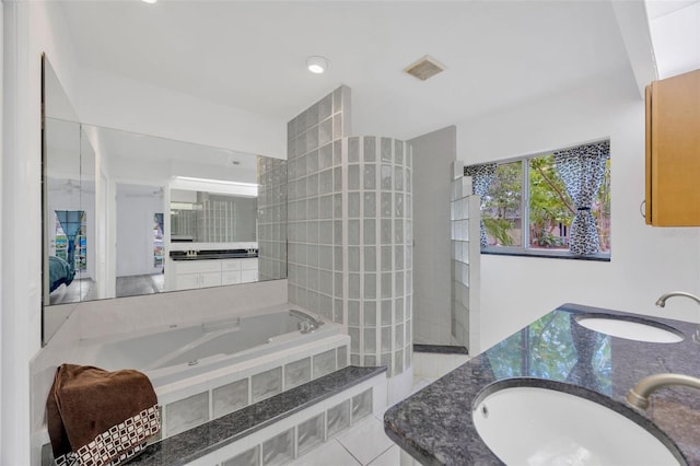 8143 Channel Dr, Port Richey, FL 34668 - full bath with a garden tub, double vanity, and tile patterned floors