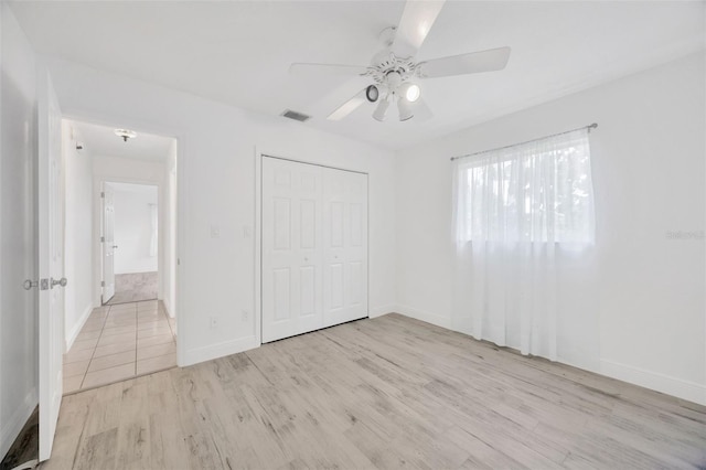 8143 Channel Dr, Port Richey, FL 34668 - unfurnished bedroom with wood finished floors, a closet, and ceiling fan