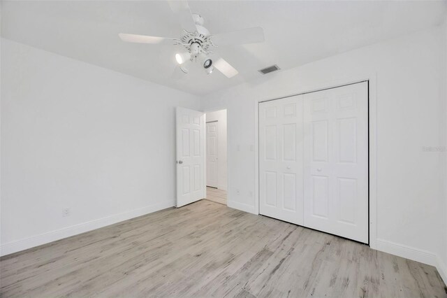 8143 Channel Dr, Port Richey, FL 34668 - unfurnished bedroom with wood finished floors, a closet, and a ceiling fan