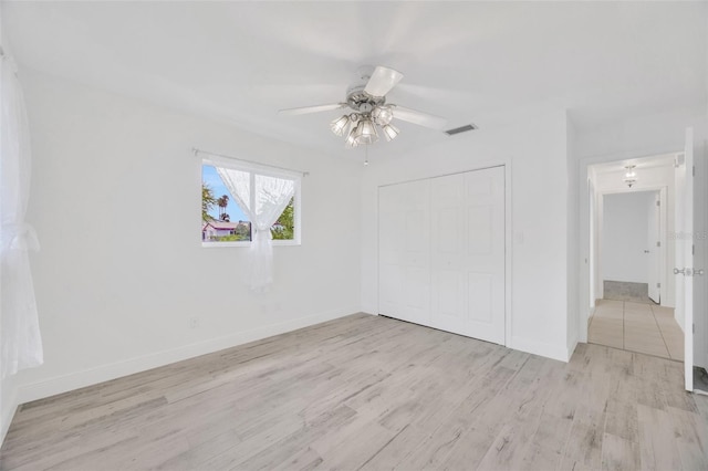 8143 Channel Dr, Port Richey, FL 34668 - unfurnished bedroom featuring wood finished floors, a closet, and ceiling fan
