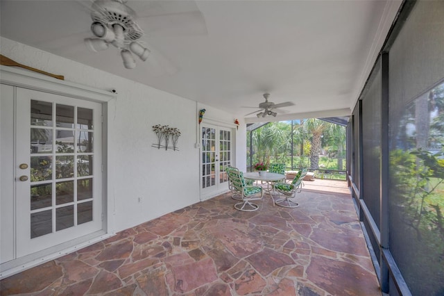 8143 Channel Dr, Port Richey, FL 34668 - unfurnished sunroom with french doors, ceiling fan, and stone floors