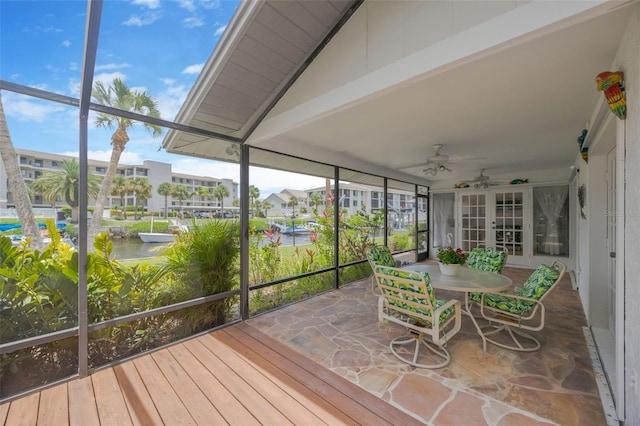 8143 Channel Dr, Port Richey, FL 34668 - sunroom featuring french doors, ceiling fan, a water view, and outdoor dining area