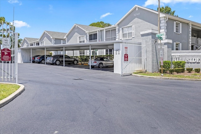 12141 Spartan Way Unit 102, Hudson, FL 34667 - view of asphalt road featuring traffic signs and curbs