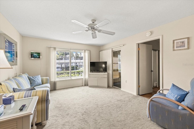 12141 Spartan Way Unit 102, Hudson, FL 34667 - carpeted living area with a ceiling fan and a textured ceiling