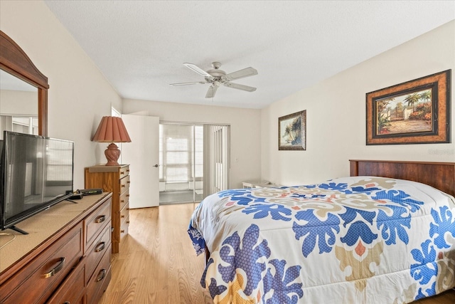 12141 Spartan Way Unit 102, Hudson, FL 34667 - bedroom with light wood-style flooring, a ceiling fan, and a textured ceiling