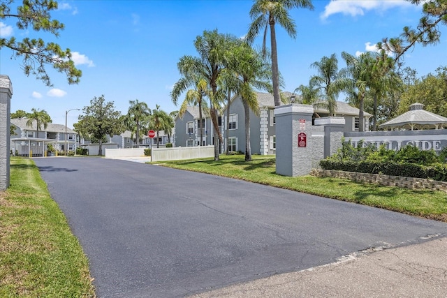 12141 Spartan Way Unit 102, Hudson, FL 34667 - view of asphalt road with a residential view, traffic signs, and street lighting