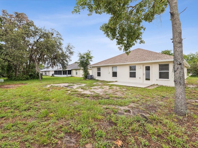 5048 Teather St, Spring Hill, FL 34608 - back of property featuring stucco siding, a patio area, and a yard