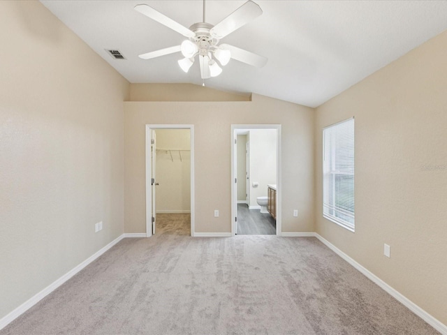5048 Teather St, Spring Hill, FL 34608 - unfurnished bedroom with lofted ceiling, a spacious closet, carpet, a closet, and a ceiling fan