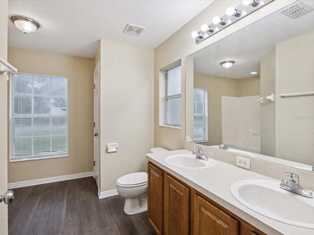 5048 Teather St, Spring Hill, FL 34608 - bathroom featuring a shower, double vanity, and wood finished floors