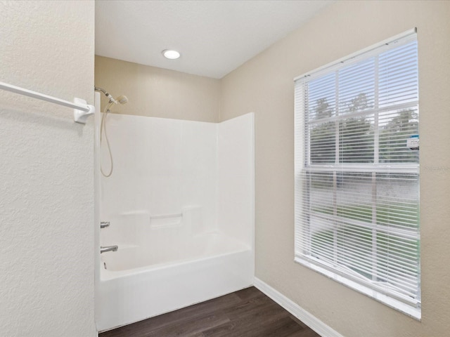5048 Teather St, Spring Hill, FL 34608 - full bath with wood finished floors, washtub / shower combination, and a textured wall
