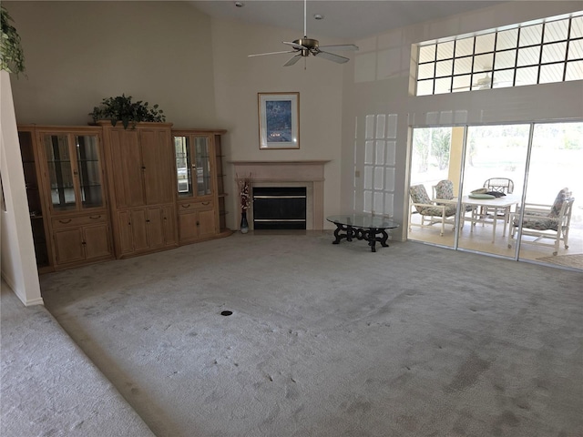 9168 Southern Comfort Ct, Weeki Wachee, FL 34613 - living area with high vaulted ceiling, light colored carpet, a fireplace, and ceiling fan