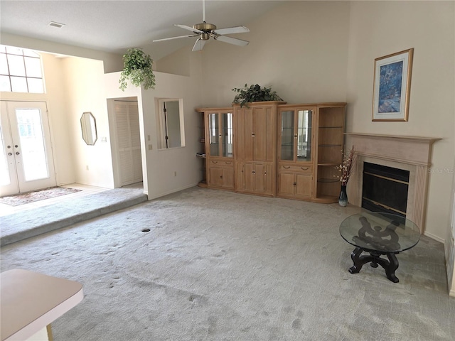 9168 Southern Comfort Ct, Weeki Wachee, FL 34613 - unfurnished living room with light carpet, plenty of natural light, a fireplace, a ceiling fan, and high vaulted ceiling