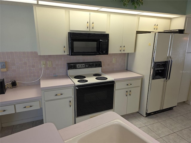 9168 Southern Comfort Ct, Weeki Wachee, FL 34613 - kitchen with white appliances, light countertops, light tile patterned floors, and backsplash