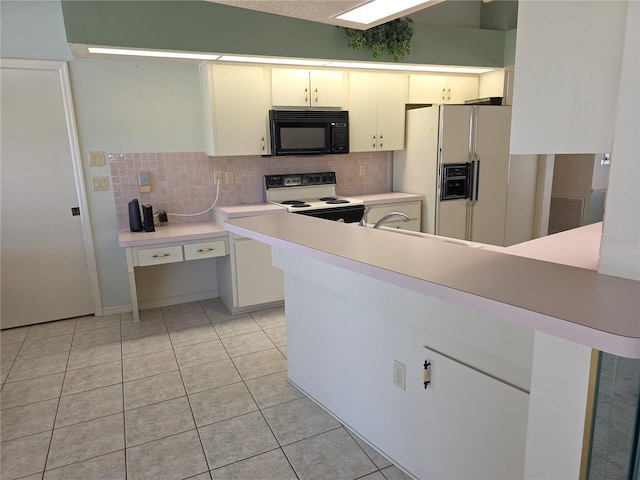 9168 Southern Comfort Ct, Weeki Wachee, FL 34613 - kitchen with white appliances, decorative backsplash, light countertops, and light tile patterned floors