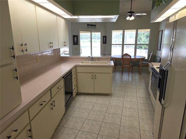 9168 Southern Comfort Ct, Weeki Wachee, FL 34613 - kitchen with white appliances, light tile patterned floors, light countertops, and decorative backsplash
