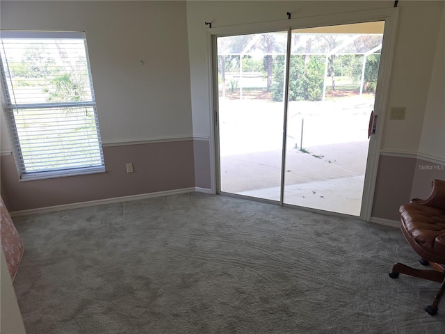 9168 Southern Comfort Ct, Weeki Wachee, FL 34613 - doorway to outside featuring plenty of natural light and carpet flooring