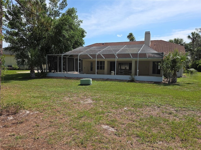 9168 Southern Comfort Ct, Weeki Wachee, FL 34613 - rear view of property with a yard, a chimney, and a lanai