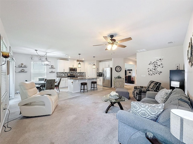 8855 Prairie Creek Dr, New Port Richey, FL 34655 - living area with a ceiling fan and light carpet