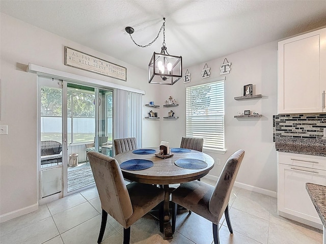 8855 Prairie Creek Dr, New Port Richey, FL 34655 - dining area featuring a chandelier, light tile patterned floors, and a textured ceiling
