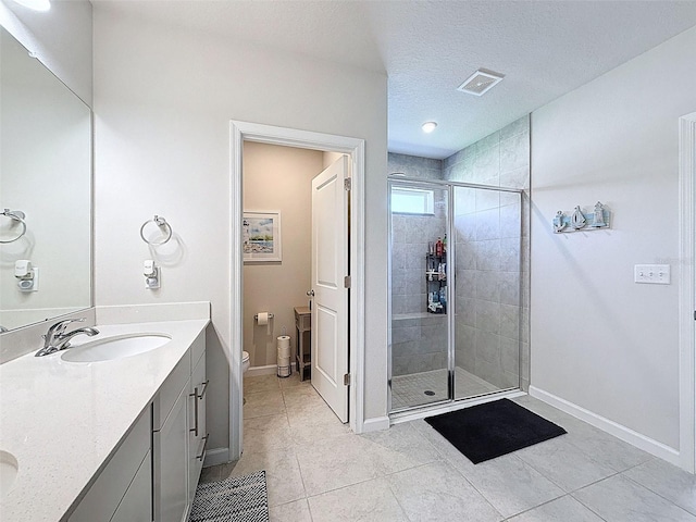 8855 Prairie Creek Dr, New Port Richey, FL 34655 - full bathroom with a shower stall, double vanity, tile patterned flooring, and a textured ceiling