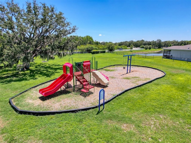 8855 Prairie Creek Dr, New Port Richey, FL 34655 - communal playground featuring a yard and view of wooded area